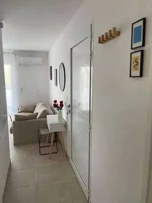 a sliding glass door in a living room with a couch at App. 2 p design zen vue mer N182 in Linguizzetta