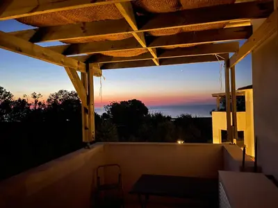 a view of the sunset from the balcony of a house at App. 2 p design zen vue mer N182 in Linguizzetta