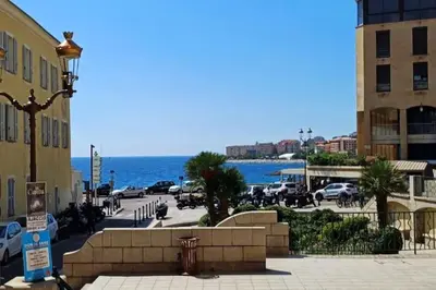 a view of a city with the ocean in the background at Appartement T2 Ajaccio vieille ville in Ajaccio