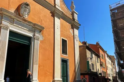 a woman is standing outside of a building at Appartement T2 Ajaccio vieille ville in Ajaccio