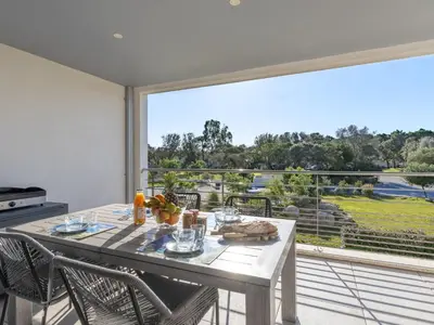 a dining room with a table and a large window at Apartment Domaine d'Arca G6 by Interhome in Porto-Vecchio