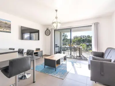 a living room with a table and chairs at Apartment Domaine d'Arca G6 by Interhome in Porto-Vecchio