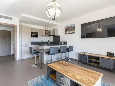 a kitchen with a table and chairs in a room at Apartment Domaine d'Arca G6 by Interhome in Porto-Vecchio