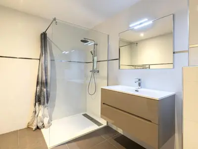a bathroom with a shower and a sink and a mirror at Apartment Domaine d'Arca G6 by Interhome in Porto-Vecchio