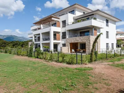 a white house with a fence in front of it at Apartment Domaine d'Arca G6 by Interhome in Porto-Vecchio