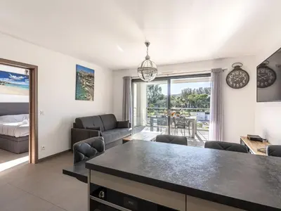 a kitchen and living room with a table and chairs at Apartment Domaine d'Arca G7 by Interhome in Porto-Vecchio