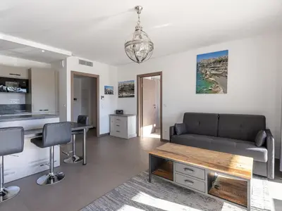 a living room with a couch and a table at Apartment Domaine d'Arca G7 by Interhome in Porto-Vecchio