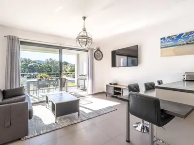 a living room with a couch and a table at Apartment Domaine d'Arca G7 by Interhome in Porto-Vecchio