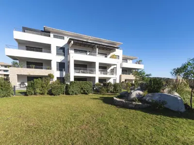 an apartment building with a yard in front of it at Apartment Domaine d'Arca G1 by Interhome in Porto-Vecchio