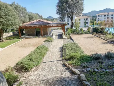 a garden with a gazebo and a building at Apartment Domaine d'Arca G1 by Interhome in Porto-Vecchio