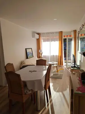 a room with a table and chairs and a bedroom at Casa D'Amore T3 in Ajaccio