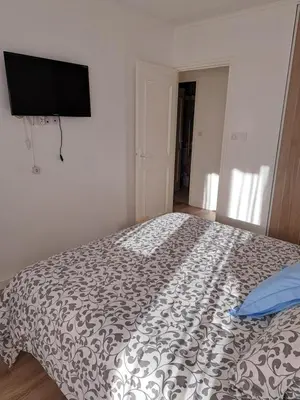 a bedroom with a bed with a black and white comforter at Casa D'Amore T3 in Ajaccio