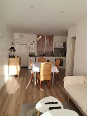 a kitchen and a living room with a table and chairs at Casa D'Amore T3 in Ajaccio