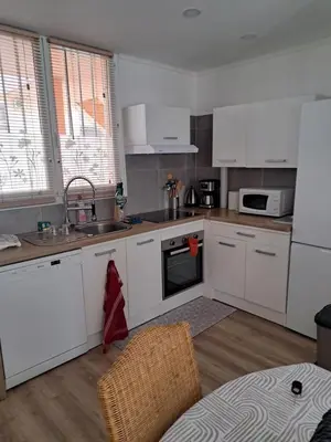 a kitchen with white cabinets and a sink at Casa D'Amore T3 in Ajaccio