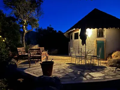 a patio with chairs and a table and a building at Maison de vacances dans village AUTHENTIQUE Corse in Bonifacio