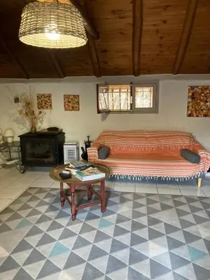 a living room with a large couch and a table at Maison de vacances dans village AUTHENTIQUE Corse in Bonifacio