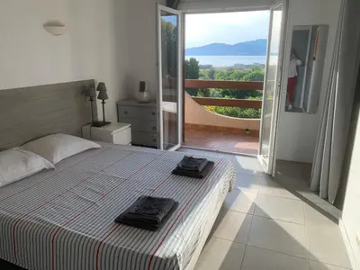 a bedroom with a bed with two towels on it at Corsicadream Arone superbe appartement dans villa, vue panoramique mer, piscine, proche Porticcio in Pietrosella