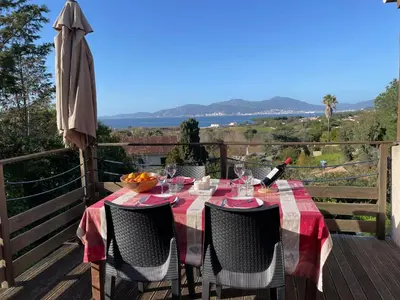 a table with a bowl of fruit on a balcony at Corsicadream Arone superbe appartement dans villa, vue panoramique mer, piscine, proche Porticcio in Pietrosella