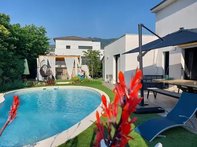 a swimming pool in the yard of a house at Chez Cendra in Borgo