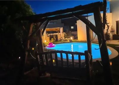 a pool in the backyard of a house at night at Chez Cendra in Borgo