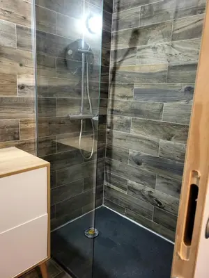 a bathroom with a shower with a glass door at L anghjuledda 2 in Grosseto-Prugna