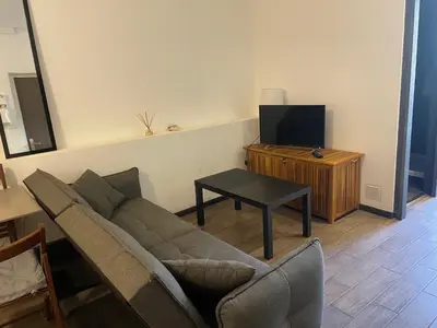 a living room with a couch and a table at Studio cosy en centre d'Ajaccio in Ajaccio