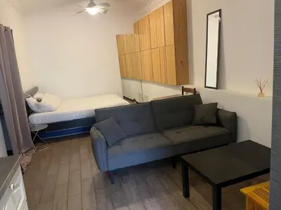 a living room with a couch and a bed at Studio cosy en centre d'Ajaccio in Ajaccio