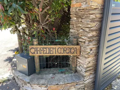 a sign for a garden center on a stone wall at Carpediem corsica adult only in Poggio-dʼOletta