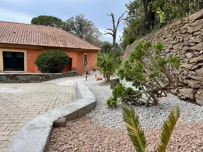 a house with a stone pathway next to a building at Carpediem corsica adult only in Poggio-dʼOletta
