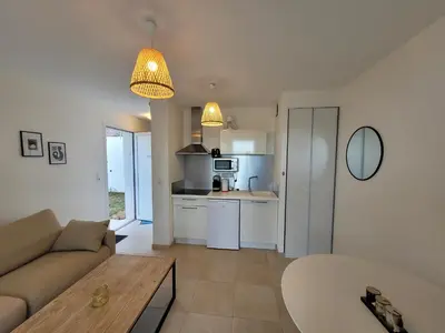 a living room with a couch and a table at Superbe appartement vue mer terrasse couverte face à la mer in Linguizzetta