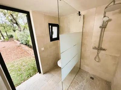 a bathroom with a shower with a glass door at Villa Nasya, 8 pers, piscine chauffée, 5 mn plage voiture in Gialla