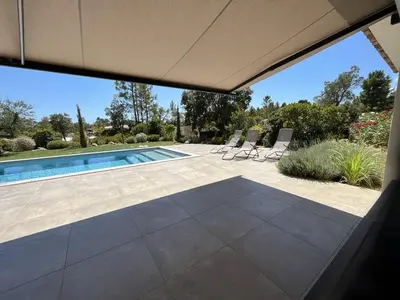 an external view of a swimming pool with a patio at Villa Nasya, 8 pers, piscine chauffée, 5 mn plage voiture in Gialla