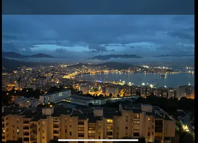 a view of a city at night at Appartement dominant la baie d'Ajaccio in Ajaccio