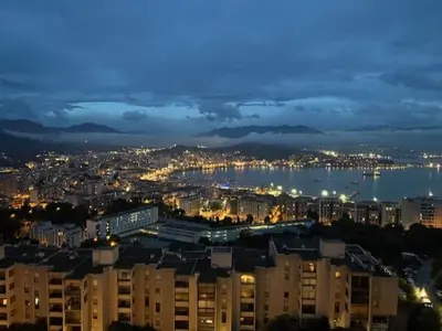 a view of a city at night with buildings at Appartement dominant la baie d'Ajaccio in Ajaccio