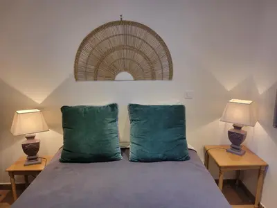 a bedroom with a bed with two lamps on tables at A VIGNA VECCHIA - CHARMANT 3 PIECES SUD PORTO VECCHIO in Porto-Vecchio