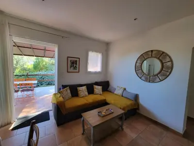 a living room with a couch and a table at A VIGNA VECCHIA - CHARMANT 3 PIECES SUD PORTO VECCHIO in Porto-Vecchio