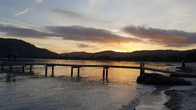 a sunset over a body of water with a pier at A VIGNA VECCHIA - CHARMANT 3 PIECES SUD PORTO VECCHIO in Porto-Vecchio