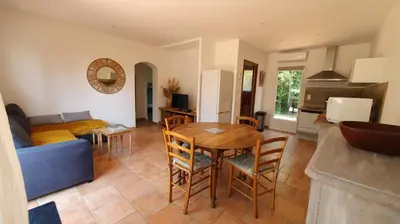 a living room with a table and a couch at A VIGNA VECCHIA - CHARMANT 3 PIECES SUD PORTO VECCHIO in Porto-Vecchio