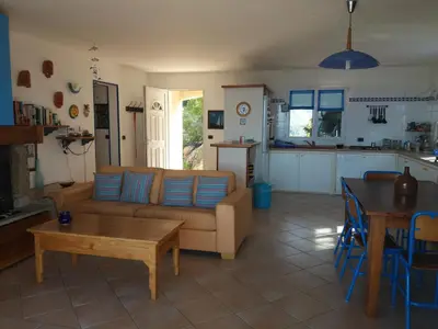 a living room with a couch and a table at villa marina in Sartène