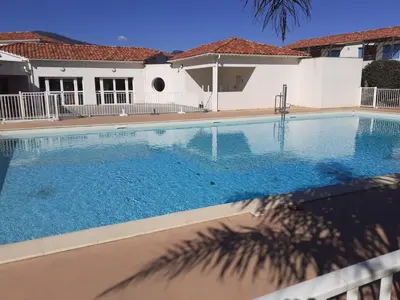 a large swimming pool in front of a house at Bel appartement avec piscine- Poggio Mezzana in Poggio-Mezzana