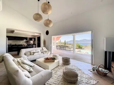 a living room with a white couch and a large window at Luxury Villa with Stunning Panoramic Views in Grosseto-Prugna
