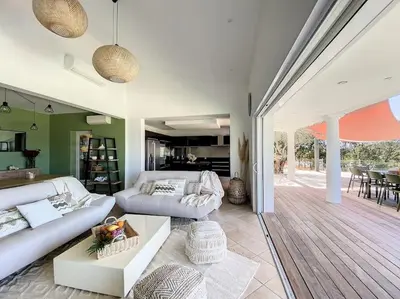 a living room with two white couches and a table at Luxury Villa with Stunning Panoramic Views in Grosseto-Prugna