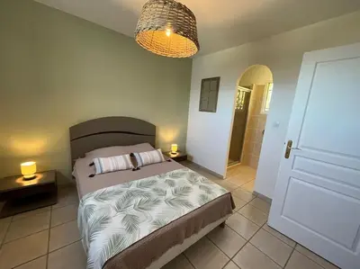 a bedroom with a bed and a chandelier at Luxury Villa with Stunning Panoramic Views in Grosseto-Prugna