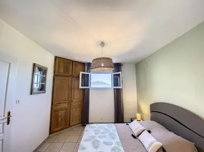 a bedroom with a bed and a large window at Luxury Villa with Stunning Panoramic Views in Grosseto-Prugna