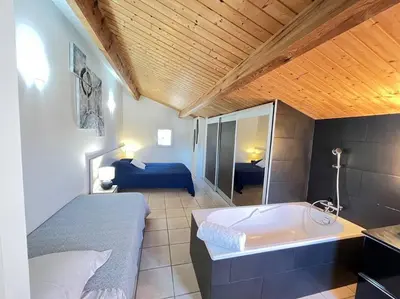 a bedroom with a white bed and a chandelier at Luxury Villa with Stunning Panoramic Views in Grosseto-Prugna