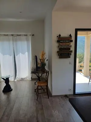 a living room with a mirror and a table and a window at VILLA I BAGHI - sans vis-à-vis au calme in Sainte-Lucie de Porto-Vecchio