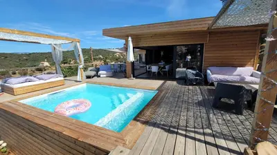 a backyard with a swimming pool and a deck at A Dimora di Murza Liliekaena in Albitreccia