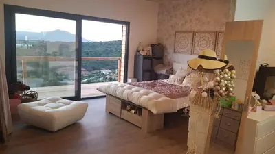 a bedroom with a bed and a large window at A Dimora di Murza Liliekaena in Albitreccia