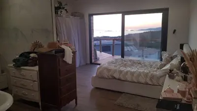 a bedroom with a bed and a dresser and a balcony at A Dimora di Murza Liliekaena in Albitreccia