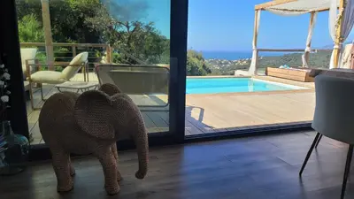 a teddy bear standing in a living room next to a sliding door at A Dimora di Murza Liliekaena in Albitreccia